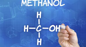 Hand with pen drawing the chemical formula of Methanol
